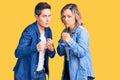 Couple of women wearing casual clothes ready to fight with fist defense gesture, angry and upset face, afraid of problem
