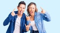 Couple of women wearing casual clothes shouting with crazy expression doing rock symbol with hands up Royalty Free Stock Photo