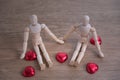 A couple of wooden doll man on valentine days showing love to each other Royalty Free Stock Photo