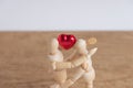 A couple of wooden doll man on valentine days showing love to each other Royalty Free Stock Photo