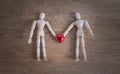 A couple of wooden doll man on valentine days showing love to each other Royalty Free Stock Photo