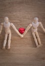 A couple of wooden doll man on valentine days showing love to each other Royalty Free Stock Photo