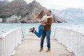 Couple on wooden pier near the sea in autumn Royalty Free Stock Photo