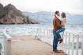 Couple on wooden pier near the sea in autumn Royalty Free Stock Photo