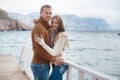 Couple on wooden pier near the sea in autumn Royalty Free Stock Photo