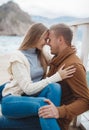 Couple on wooden pier near the sea in autumn Royalty Free Stock Photo