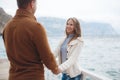 Couple on wooden pier near the sea in autumn Royalty Free Stock Photo