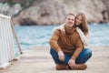 Couple on wooden pier near the sea in autumn Royalty Free Stock Photo