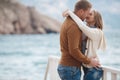 Couple on wooden pier near the sea in autumn Royalty Free Stock Photo