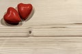 Couple of Wooden Red Hearts on a Light Wooden Background