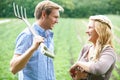 Couple Working In Field On Organic Farm Royalty Free Stock Photo