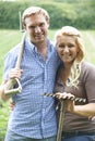 Couple Working In Field On Organic Farm Royalty Free Stock Photo