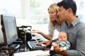 Couple working in home office with baby Royalty Free Stock Photo