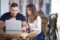 Couple working with laptop at a cafe Royalty Free Stock Photo