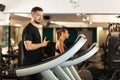 Couple working out on a treadmil in a fitness club Royalty Free Stock Photo