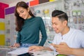 a couple working together checking the records of cell phone accessories Royalty Free Stock Photo