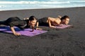 Couple Workout On Beach. Handsome Man And Sexy Woman In Fashion Sporty Outfit Doing Push-Ups On Yoga Mat In Morning. Royalty Free Stock Photo