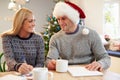 Couple Writing Christmas Cards Together Royalty Free Stock Photo