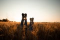 Couple's legs over grain field and sky Royalty Free Stock Photo