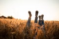 Couple's legs over grain field and sky Royalty Free Stock Photo