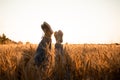 Couple's legs over grain field and sky Royalty Free Stock Photo