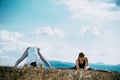 Outdoor shot of couple doing yoga exercise at the hill Royalty Free Stock Photo