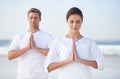 Couple, yoga and meditation on beach, prayer for zen and wellness, travel and mindfulness with holistic healing. People Royalty Free Stock Photo