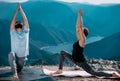 Outdoor shot of couple doing yoga exercise at the hill Royalty Free Stock Photo