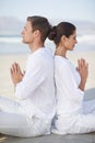 Couple, yoga and sea with meditation, peace and waves on sand in morning with mindfulness in summer. Man, woman and Royalty Free Stock Photo