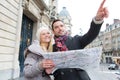 Couple of young attractive tourist watching map