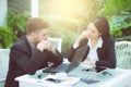 Couple of young business working at modern office, two coworkers discussing fun project over a laptop. Royalty Free Stock Photo