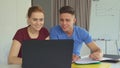 Couple of young people works on laptop at the office Royalty Free Stock Photo