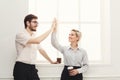 Couple of young colleagues drink coffee near window Royalty Free Stock Photo