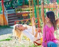 Couple of young fashion girls have fun on flying carousel in amusement park summer Royalty Free Stock Photo