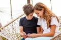 Couple of young happy teenagers. A girl and a guy laugh and watch a video together on a smartphone Royalty Free Stock Photo