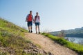 Young Happy Couple Hiking with Backpacks on the Beautiful Rocky Trail at Sunny Evening. Family Travel and Adventure. Royalty Free Stock Photo