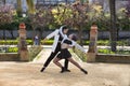 Couple of young Latin women dancing bachata in an outdoor park, performing different dance figures. Concept dances, urban, latin Royalty Free Stock Photo