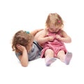 Couple of young little girl sitting over isolated white background Royalty Free Stock Photo