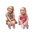 Couple of young little girl sitting over isolated white background Royalty Free Stock Photo