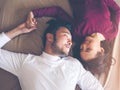 Couple of young lover playful laying down on the bed talking funny story in the weekend. Lover have a happy time Royalty Free Stock Photo