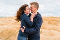 A couple of young lovers a man and a woman in the desert with sand dunes of bizarre shape Royalty Free Stock Photo