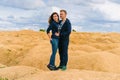 A couple of young lovers a man and a woman in the desert with sand dunes of bizarre shape Royalty Free Stock Photo