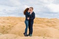 A couple of young lovers a man and a woman in the desert with sand dunes of bizarre shape Royalty Free Stock Photo