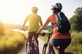 Couple of young man and woman cycling together along the road at sunset time, Generative Ai Royalty Free Stock Photo