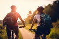 Couple of young man and woman cycling together along the road at sunset time, Generative Ai Royalty Free Stock Photo