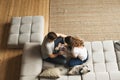 Couple young man and woman at home together, sitting on sofa Royalty Free Stock Photo