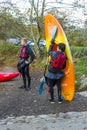 A couple of young men clearing their boating equipment after an afternoon of kayak training on the lake in Castlewellan Forest Par Royalty Free Stock Photo