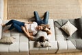 Couple young man and woman at home together, lying on sofa Royalty Free Stock Photo