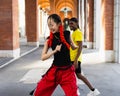 Couple of young modern urban dancers having fun dancing in the street