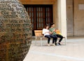 A couple of young people are attentively checking their mobile phones Royalty Free Stock Photo